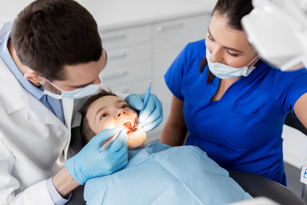 An expert performing dentistry on a child in Tweed Heads