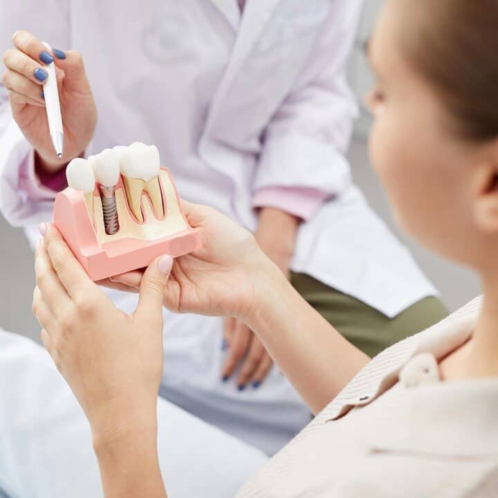 A dentist explaining the dental implant process