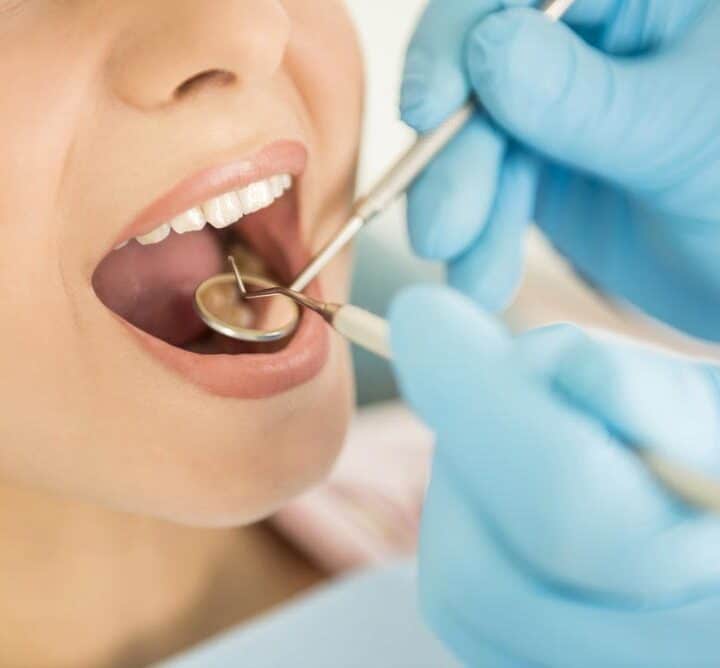 Dentist Checking The Teeth Of A Patient